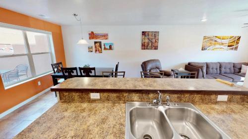 a kitchen with a sink and a living room at Slick Rock Reserve #12A3 in Moab