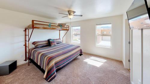 a bedroom with a bunk bed and two windows at Slick Rock Reserve #12A3 in Moab