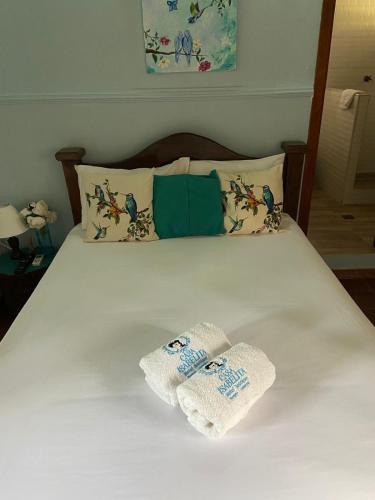 two towels are sitting on a bed at Casa Isabelita in Mompos