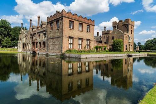 an old castle with its reflection in a body of water at Double Bedroom, Kings Lynn, New Renovated Bathroom in Kings Lynn