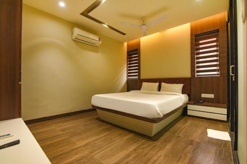 a bedroom with a bed and a window at FabHotel Eros 282 in Kolkata