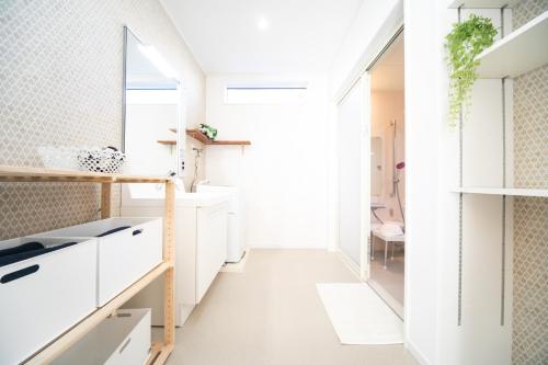 a kitchen with white cabinets and a window at Shizukinosato TSUKI Terrace 531 in Awaji