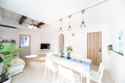 a white living room with a white table and chairs at Shizukinosato TSUKI Terrace 531 in Awaji