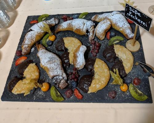 a display of different types of food on a table at Rheinauer Hof - bed & breakfast in Mannheim
