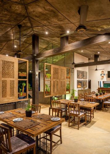 a dining room with wooden tables and chairs at Wild Culture Yala in Yala