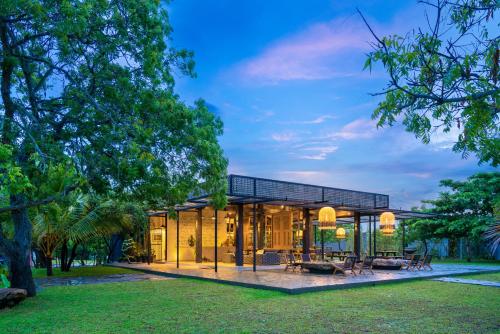 a glass house in the middle of a park at Wild Culture Yala in Yala