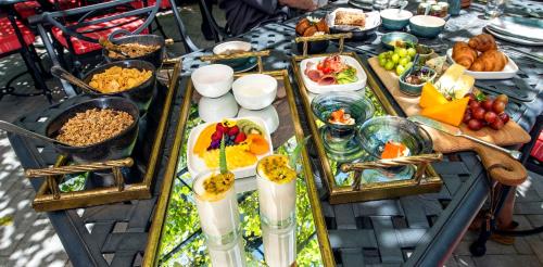 a table with a buffet of food on it at La Fontaine Boutique Hotel by The Oyster Collection in Franschhoek