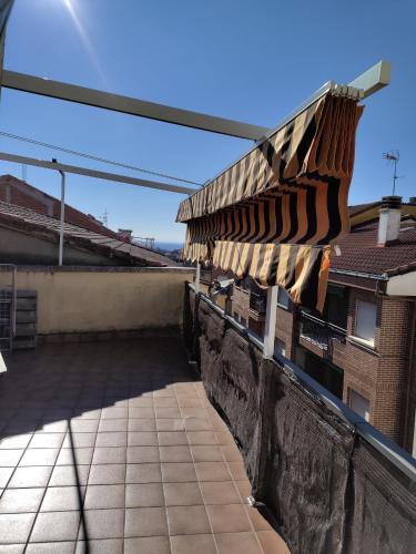 awning on top of a building on a roof at Apartamentos El Mirador in Candeleda