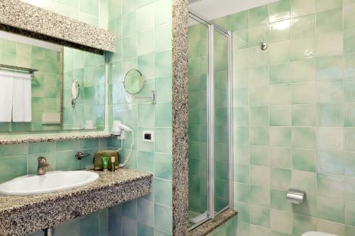 a bathroom with a sink and a shower at Sentido Orosei Beach in Orosei