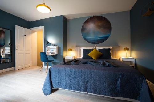 a bedroom with a bed with a painting on the wall at B&B Gaudium XII in Tongeren