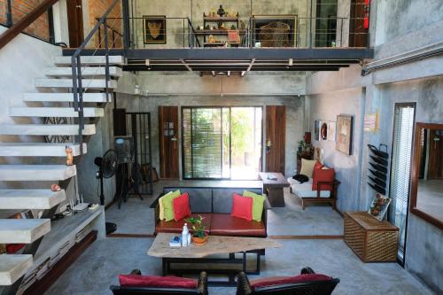 a living room with a staircase and a couch at Aonang Third Place Hometel in Ao Nang Beach