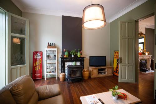 a living room with a couch and a fireplace at B&B Gaudium XII in Tongeren