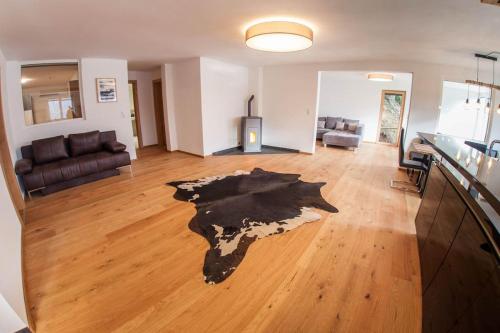 a view of a living room with a piece of art on the floor at Alpenblick de Luxe in Oetz