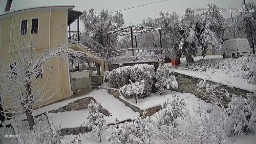 a house with a snow covered yard with a balcony at villa Belian 3 in Argalasti