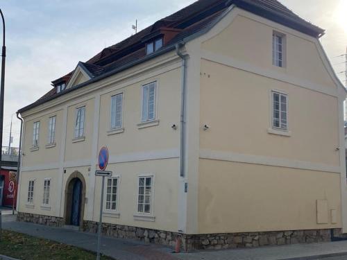 a white building on the side of a street at Vila Lucia - Apartmán 2 in Plzeň