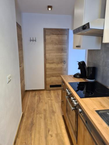 a kitchen with wooden counters and a stove top oven at Hotel Pension Annerlhof in Maria Alm am Steinernen Meer