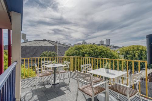 a patio with tables and chairs on a balcony at The Wharf Inn in San Francisco