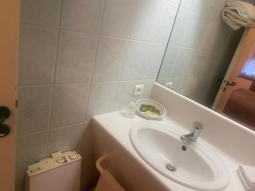 a bathroom with a sink and a toilet at hôtel du commerce in Joncy