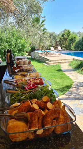 a buffet of food on a table next to a pool at Bir Dem Urla in Urla