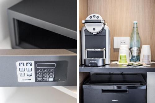 a kitchen with a coffee maker and a microwave at Felix Hotels - Hotel Felix Olbia in Olbia
