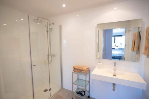 a bathroom with a sink and a shower at Go Donosti Chillida in San Sebastián