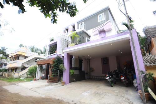 a house with a motorcycle parked in front of it at The Ideal Nest Kumbakonam in Kumbakonam
