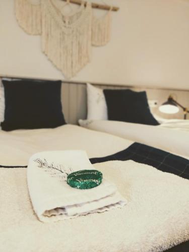 a pile of towels on a bed with two beds at Grásteinn Guesthouse in Þórshöfn