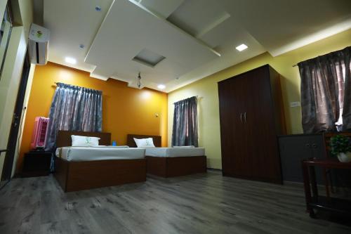 a hospital room with two beds at The Ideal Nest Kumbakonam in Kumbakonam