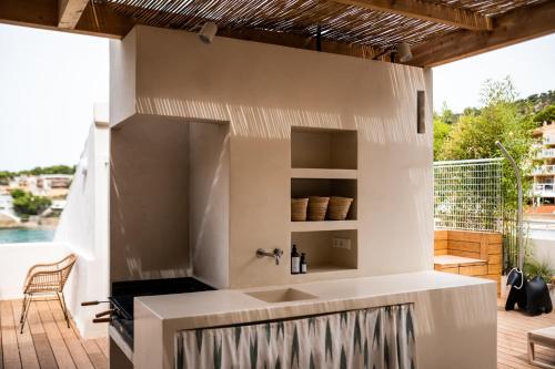 a bathroom with a sink on a deck at JUST EXPERIENCE MALLORCA in Andratx