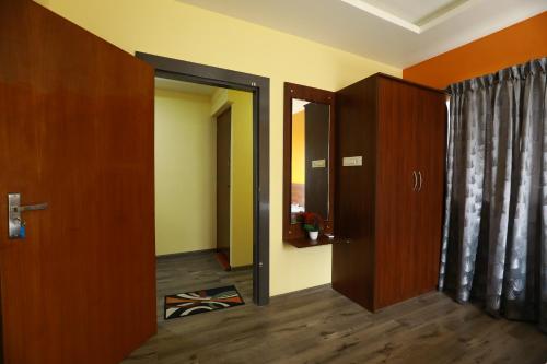 a hallway with a door and a room with a door at The Ideal Nest Kumbakonam in Kumbakonam