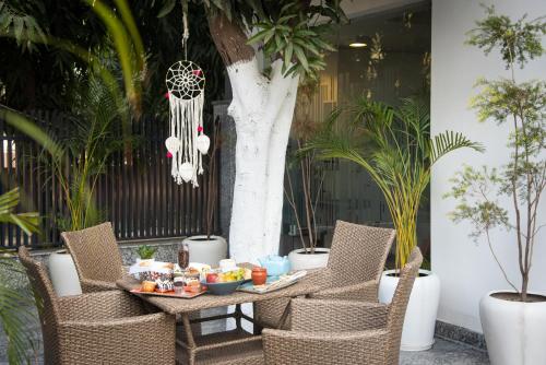 a table and chairs with food on a table at ROSASTAYS Gurugram Sec 31 in Gurgaon