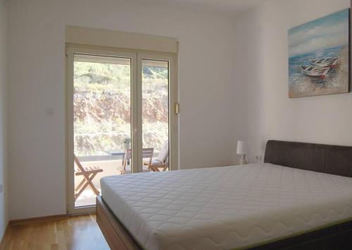 a bedroom with a bed and a sliding glass door at Status-M Apartments 85 in Bečići