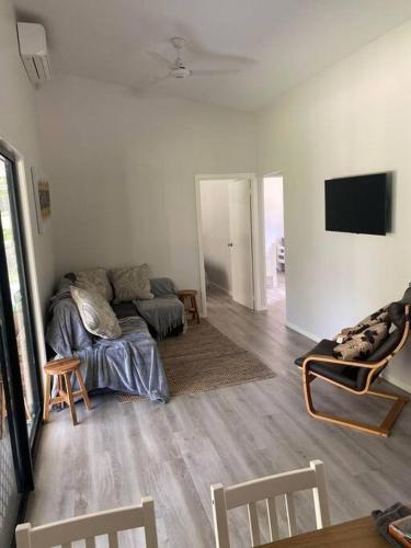 a living room with a couch and a tv at Rural Self Contained 3 bedroom Cottage on acreage, in Landsborough