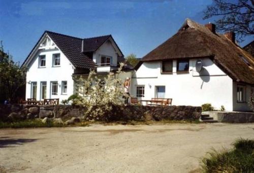 a large white house with a thatched roof at Ruegen Fewo 126 in Groß Zicker
