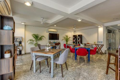 a dining room with a table and chairs at ROSASTAYS Gurugram Sec 31 in Gurgaon