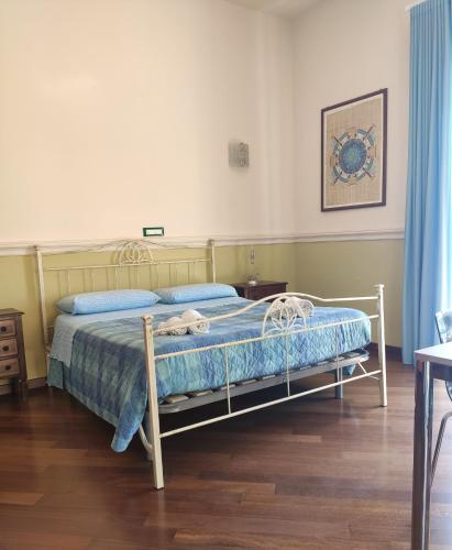 a bedroom with a bed with a blue comforter at Casa Angelica Cetara Albergo Diffuso in Cetara