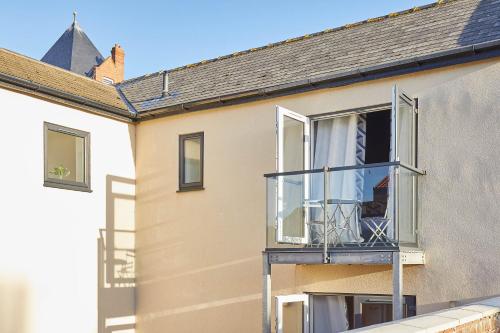 a building with a balcony with a white curtain at Host & Stay - West Cliff Retreat in Whitby