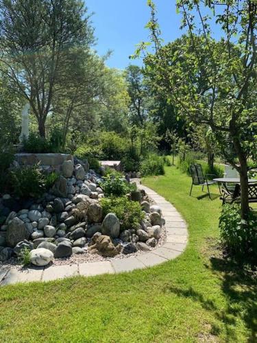 a rock garden with a bench in a park at Ferien Haus am Feldgarten mit 160 qm für 2 bis 9 Personen in Raubling