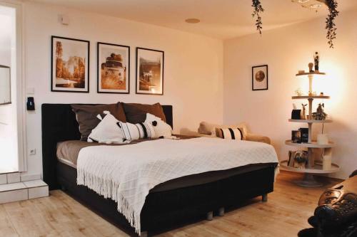 a bedroom with a large bed with pillows on it at Smart-Apartment BlickWinkel Schwarzwald in Gaggenau