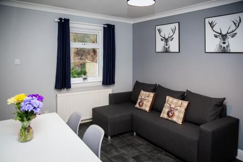 a living room with a couch and a table at St Andrews Guest House in Irvine