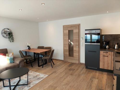 a kitchen and a dining room with a table and a kitchen at Appartements Emilia in Ehrwald