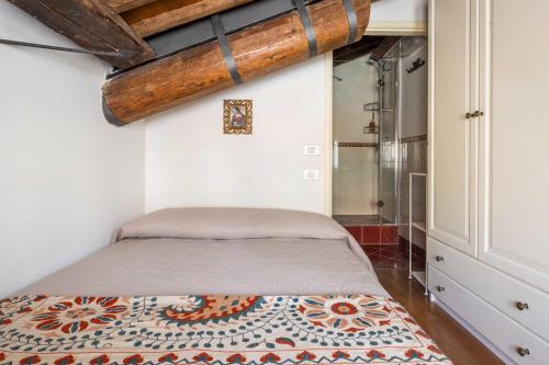 a bedroom with a bed in a room at Palazzo Benassi Penthouse in Asolo