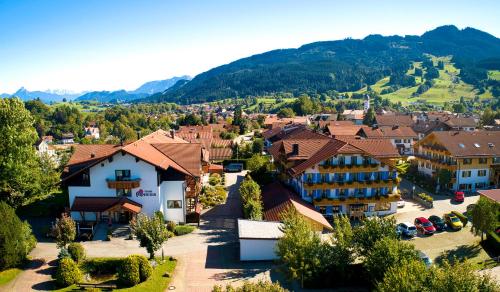 an aerial view of a small town in the mountains at Akzenthaus Alpenrose Nesselwang in Nesselwang