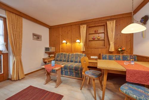 a living room with a couch and a table at Landhaus Franziskus in Reit im Winkl