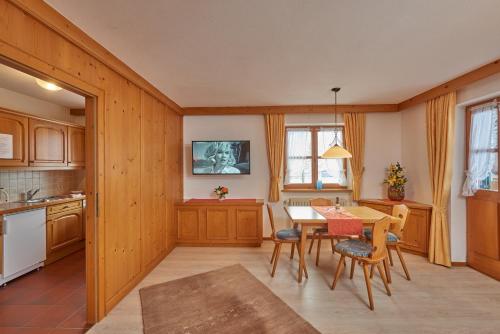 a kitchen and dining room with a table and chairs at Landhaus Franziskus in Reit im Winkl