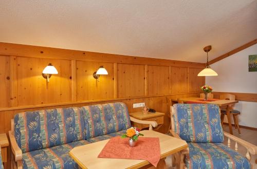 a living room with two chairs and a table at Landhaus Franziskus in Reit im Winkl