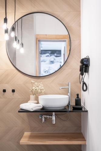 a bathroom with a sink and a mirror at Willa Bór in Zakopane