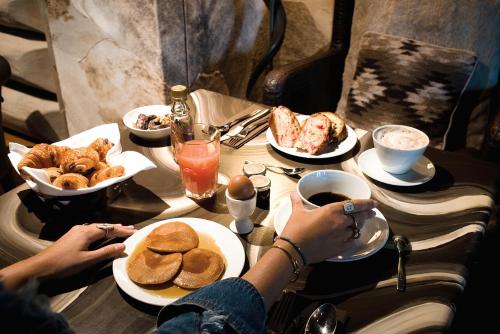 two people sitting at a table with plates of food at Lodge Park in Megève