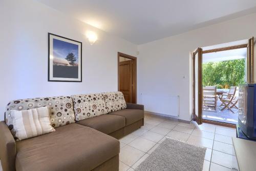a living room with a couch and a television at Villa Asi in Vrsar