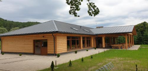 a house with a metal roof on top of it at Ośrodek Wczasów Zdrowotnych Rudawka Rymanowska in Rudawka Rymanowska